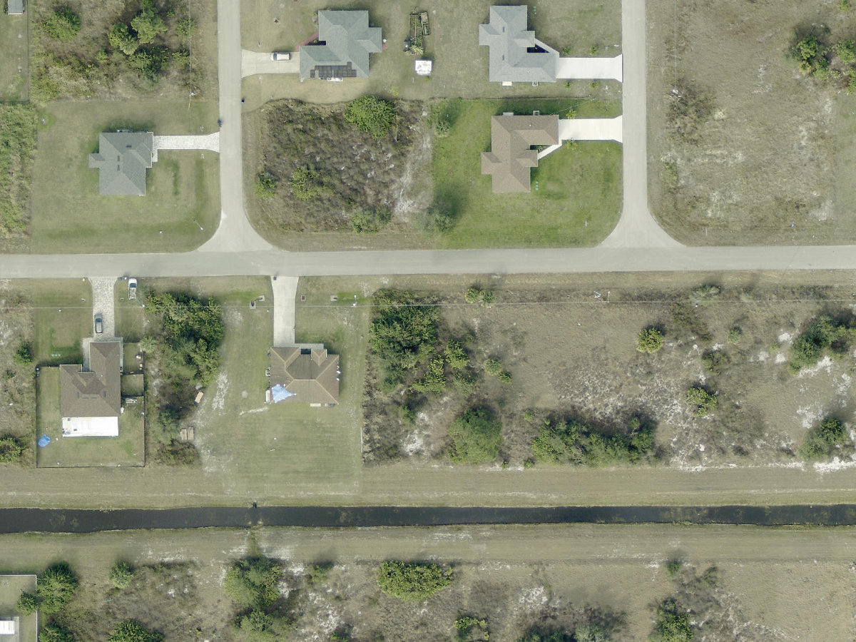 Paved-access vacant lot on Alabama Ave S, Lehigh Acres FL 33973, purchased by Lions Capital Deals